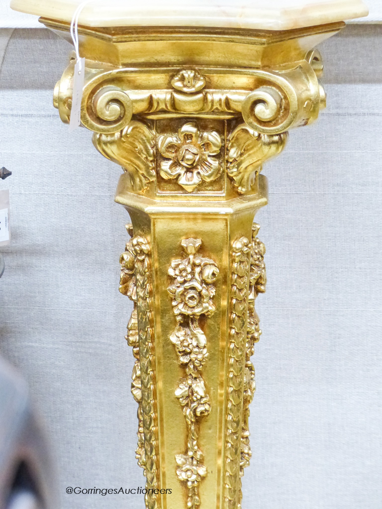 A pair of onyx top gilt pedestals, height 98cm